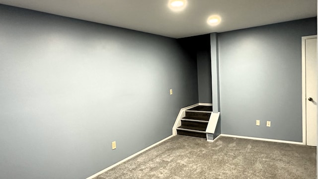 finished below grade area featuring baseboards, carpet flooring, stairs, and recessed lighting