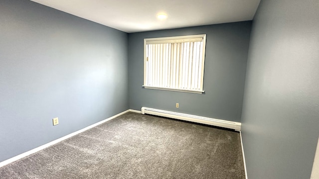 carpeted empty room featuring baseboards and baseboard heating