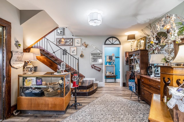 interior space featuring baseboards, wood finished floors, and stairway