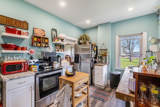 kitchen with recessed lighting, appliances with stainless steel finishes, dark wood-style flooring, and white cabinetry