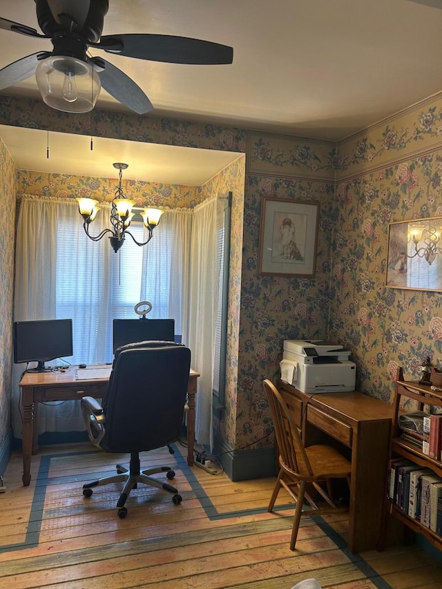 office area featuring wallpapered walls, ceiling fan with notable chandelier, and light wood-type flooring