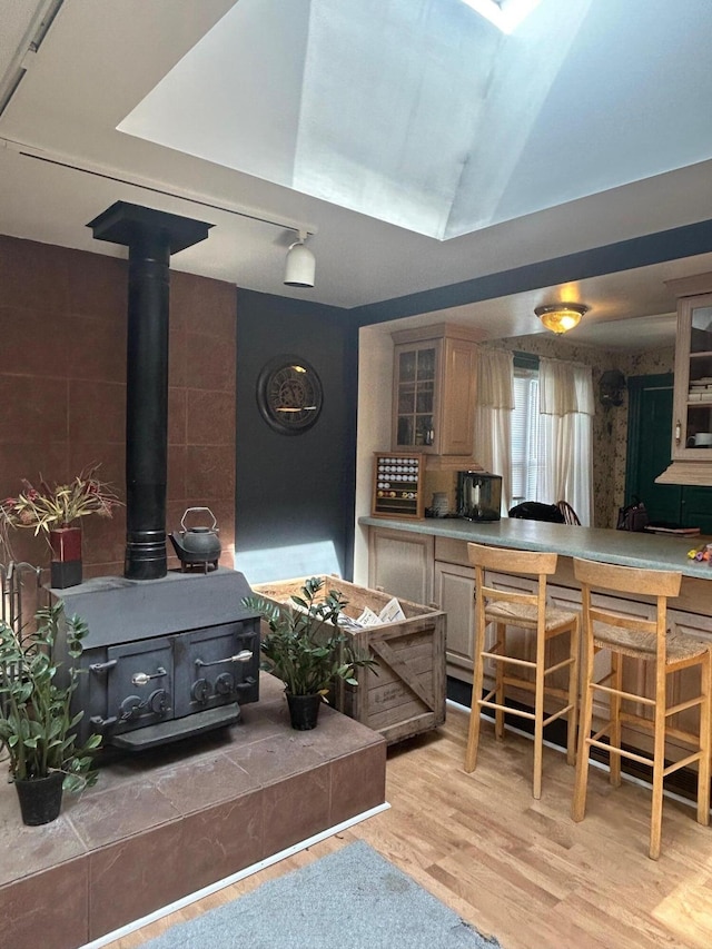 interior space with light wood-style floors and a wood stove