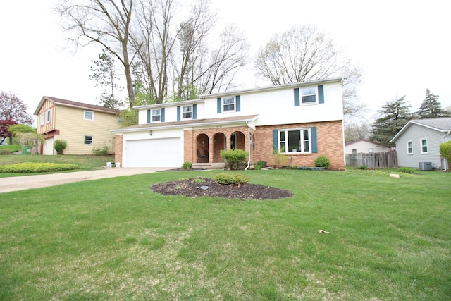traditional-style house featuring a front lawn, fence, covered porch, brick siding, and driveway