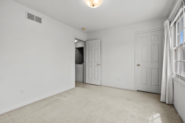 2796 Eagle Harbor Ave, Portage, MI 49024 - unfurnished bedroom featuring visible vents, baseboards, carpet floors, and multiple windows