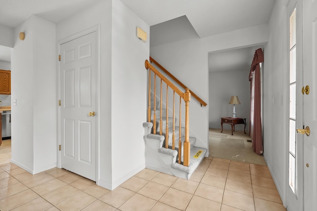 2796 Eagle Harbor Ave, Portage, MI 49024 - entryway featuring light tile patterned floors, baseboards, and stairs