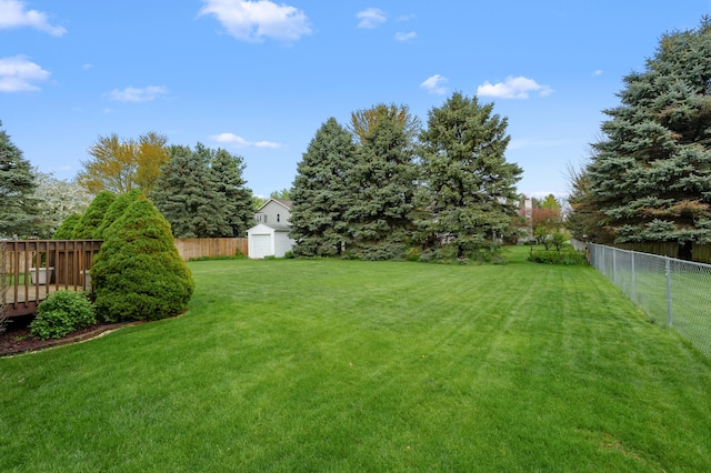 2796 Eagle Harbor Ave, Portage, MI 49024 - view of yard with an outdoor structure, a fenced backyard, and a shed
