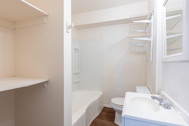bathroom featuring toilet, shower / bath combination, wood finished floors, and vanity
