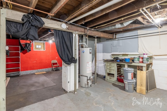 unfinished basement with water heater and a workshop area