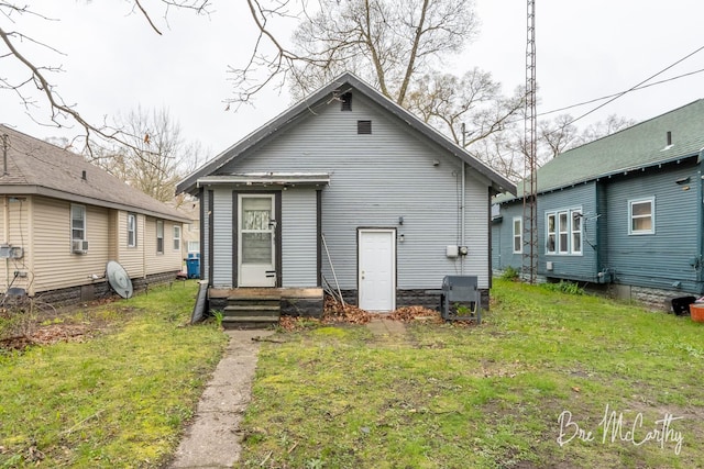 back of property featuring a yard and cooling unit