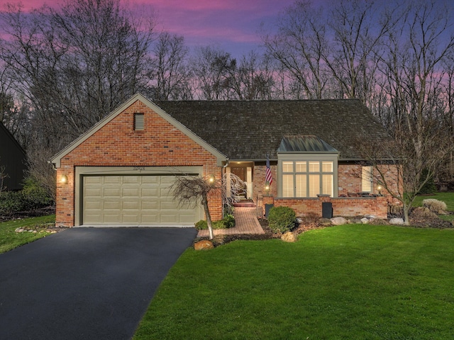 32824 Outland Trl, Bingham Farms, MI 48025 - traditional-style home with a yard, brick siding, a garage, and aphalt driveway