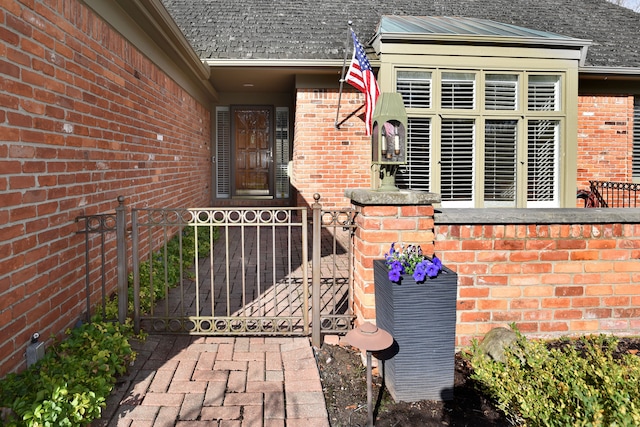 32824 Outland Trl, Bingham Farms, MI 48025 - property entrance featuring roof with shingles, fence, a gate, and brick siding