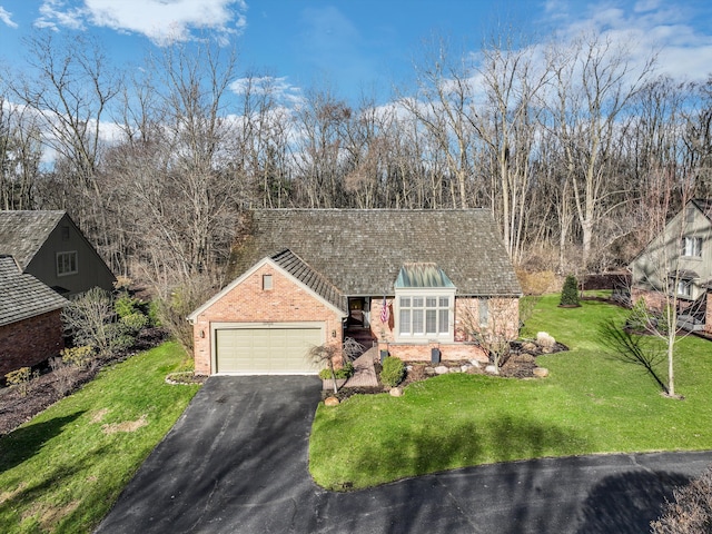 32824 Outland Trl, Bingham Farms, MI 48025 - view of front of house featuring a garage, a front lawn, aphalt driveway, roof with shingles, and brick siding