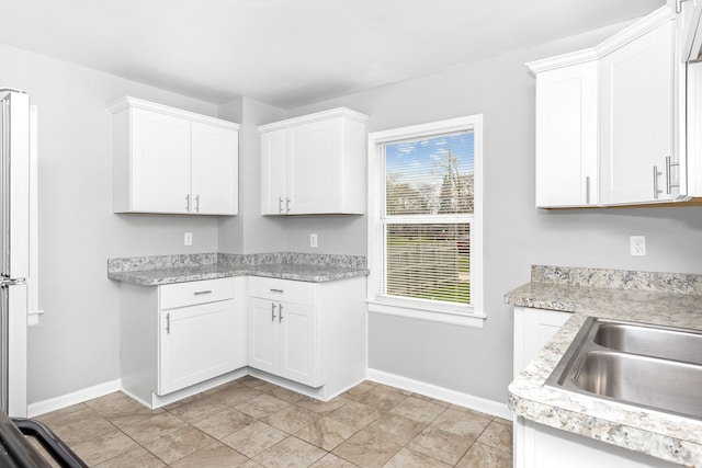 16516 Collingham Dr, Detroit, MI 48205 - kitchen with light countertops, white cabinetry, and baseboards