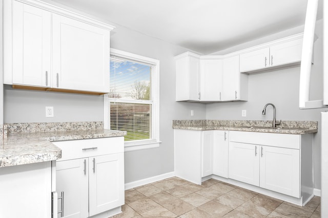 16516 Collingham Dr, Detroit, MI 48205 - kitchen featuring a sink, baseboards, and white cabinets