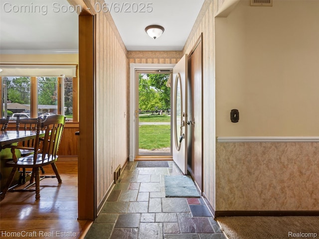 28210 Ridgebrook Rd, Farmington Hills, MI 48334 - entryway featuring crown molding, baseboards, stone tile floors, and a wainscoted wall