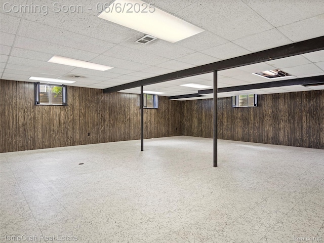 28210 Ridgebrook Rd, Farmington Hills, MI 48334 - basement with tile patterned floors, wooden walls, and a drop ceiling