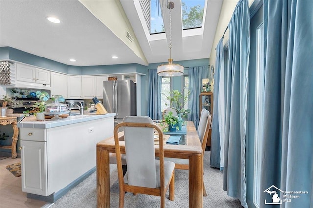 dining area featuring visible vents, recessed lighting, light carpet, and a skylight