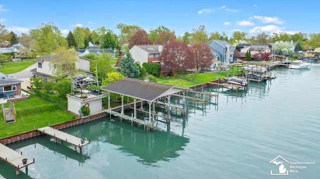 dock area with boat lift, a water view, and a residential view
