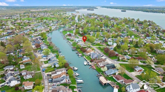 drone / aerial view featuring a residential view and a water view