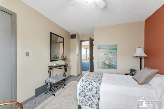 carpeted bedroom featuring a ceiling fan, a textured ceiling, visible vents, and baseboards