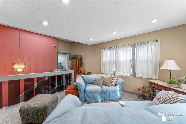 living room with carpet floors, recessed lighting, a textured ceiling, and a notable chandelier