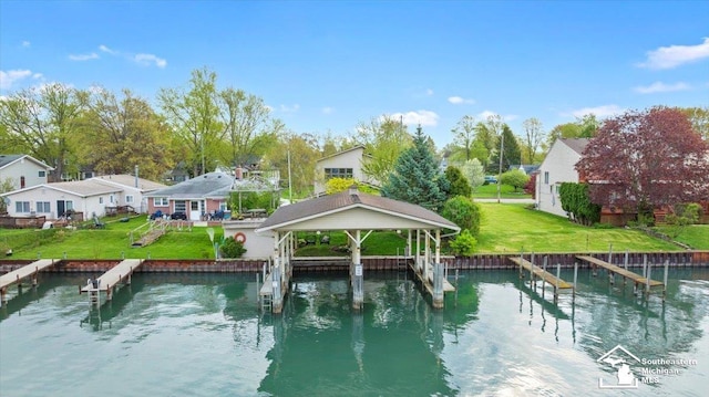 view of pool with a lawn, a water view, and a residential view