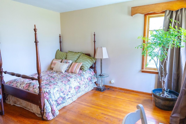 bedroom featuring baseboards and wood finished floors