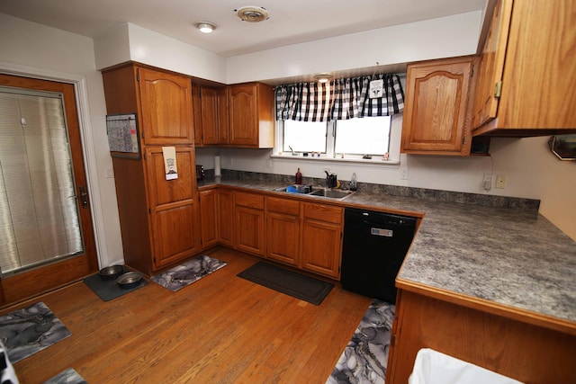 53240 Hemlock Lake Rd, Marcellus, MI 49067 - kitchen featuring dark countertops, a sink, light wood-style floors, dishwasher, and brown cabinetry