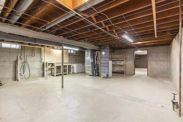 below grade area with heating unit and washer / clothes dryer