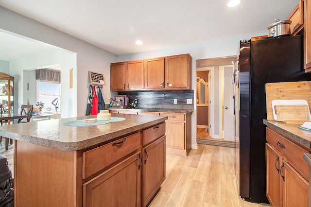 15000 Tiara Ave, Monroe, MI 48161 - kitchen with freestanding refrigerator, recessed lighting, brown cabinetry, light wood finished floors, and a kitchen island