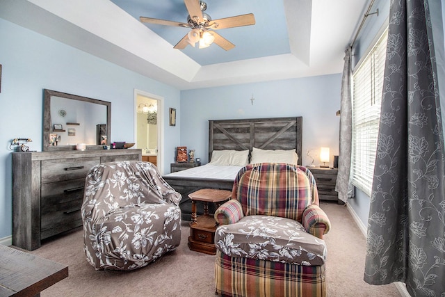 15000 Tiara Ave, Monroe, MI 48161 - carpeted bedroom with multiple windows, ensuite bathroom, baseboards, and a raised ceiling