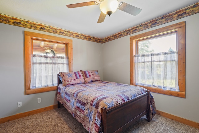 bedroom with baseboards, a ceiling fan, and carpet