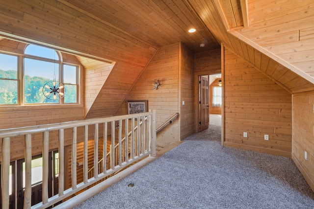 hallway with wooden walls, a healthy amount of sunlight, and wood ceiling