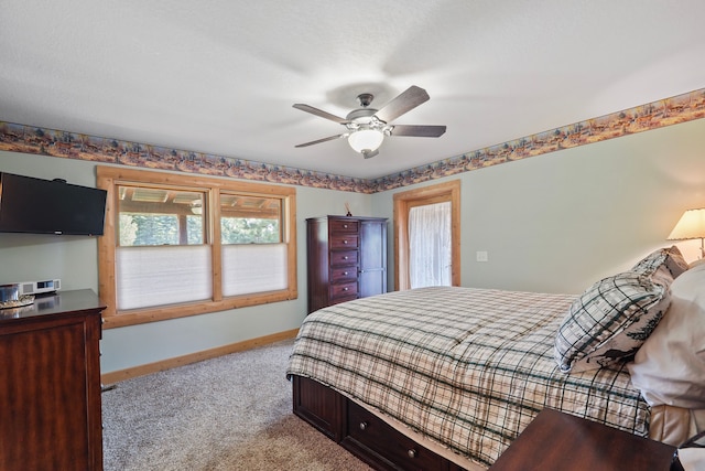 carpeted bedroom featuring baseboards and ceiling fan