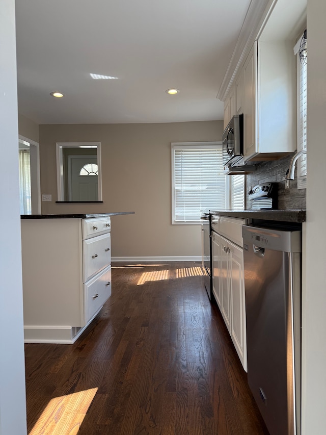 800 Cambridge Rd, Berkley, MI 48072 - kitchen with stainless steel appliances, white cabinets, dark countertops, baseboards, and dark wood-style flooring