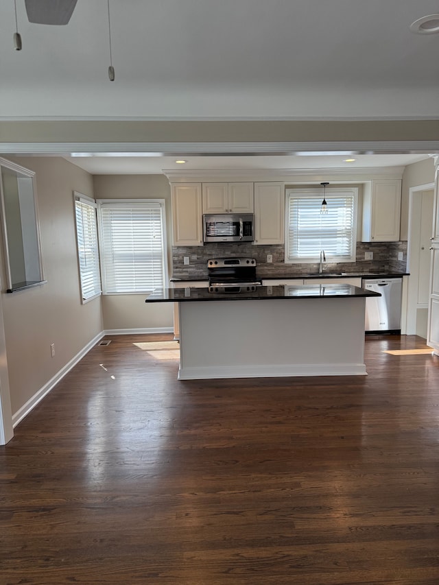 800 Cambridge Rd, Berkley, MI 48072 - kitchen featuring appliances with stainless steel finishes, dark countertops, backsplash, baseboards, and dark wood-style floors