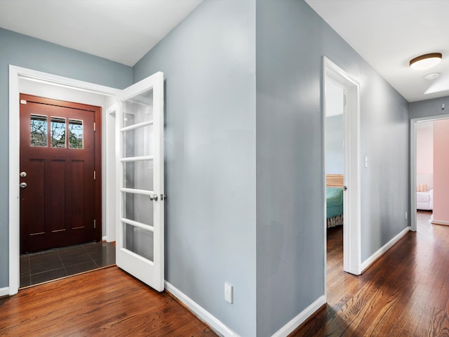 entryway featuring wood finished floors and baseboards