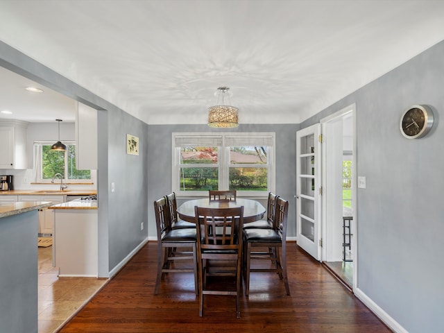 dining space featuring baseboards and wood finished floors