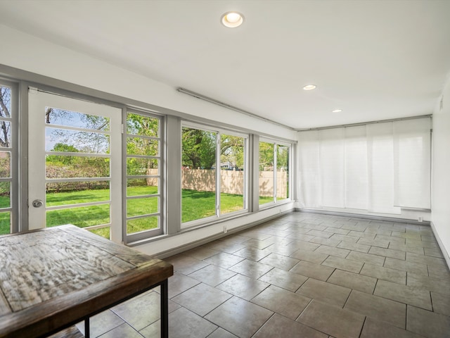 sunroom / solarium with recessed lighting and tile patterned floors