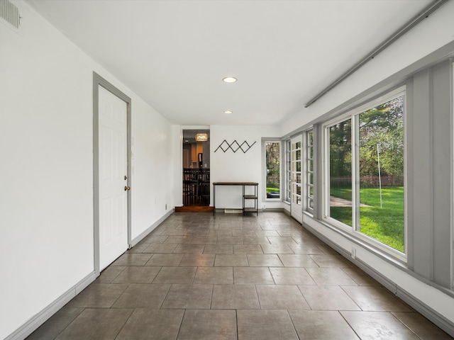unfurnished sunroom featuring recessed lighting, baseboards, tile patterned flooring, and french doors