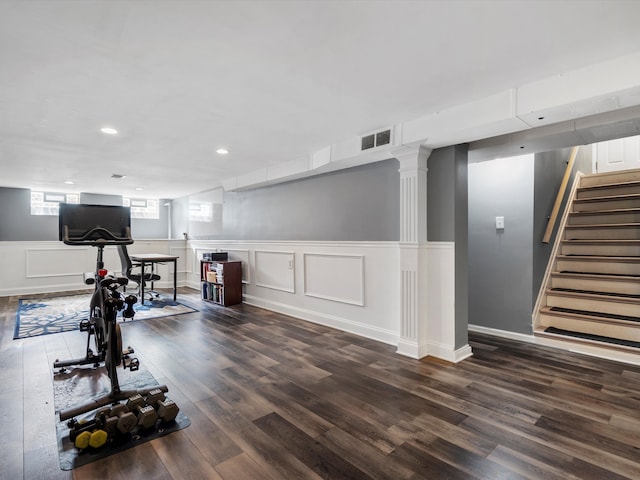 exercise area with dark wood-type flooring and recessed lighting