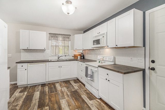 kitchen featuring backsplash, a sink, white cabinets, dark wood-style floors, and white appliances