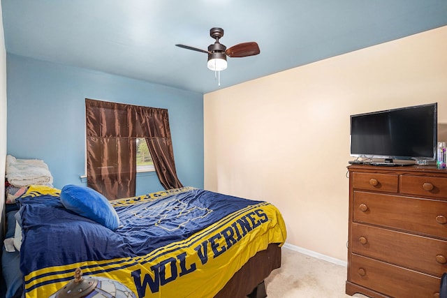 bedroom with baseboards, a ceiling fan, and light carpet