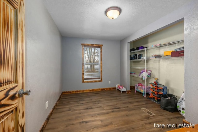 4731 N Osborn Rd, Riverdale, MI 48877 - game room featuring visible vents, baseboards, a textured ceiling, and wood finished floors
