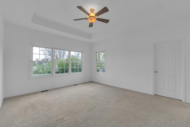 9080 Emerson Dr, Saline, MI 48176 - carpeted empty room featuring a raised ceiling, ceiling fan, baseboards, and visible vents