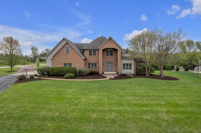9080 Emerson Dr, Saline, MI 48176 - traditional-style home featuring brick siding and a front lawn