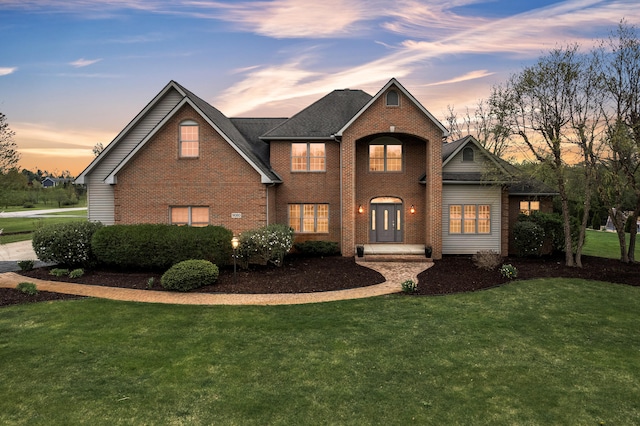 9080 Emerson Dr, Saline, MI 48176 - traditional-style house with a front yard and brick siding