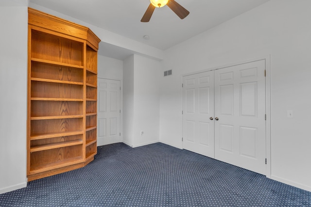 9080 Emerson Dr, Saline, MI 48176 - unfurnished bedroom with baseboards, dark carpet, and visible vents