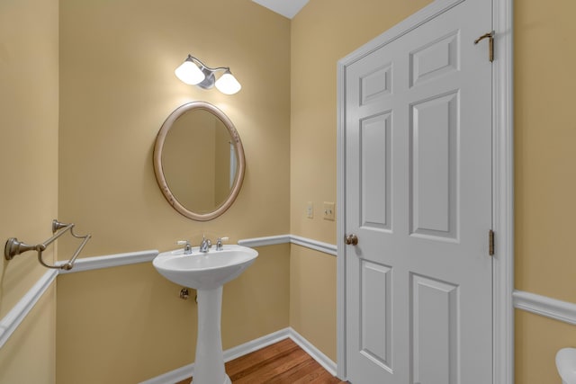 9080 Emerson Dr, Saline, MI 48176 - bathroom with a sink, baseboards, and wood finished floors