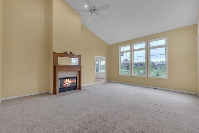 9080 Emerson Dr, Saline, MI 48176 - unfurnished living room with a ceiling fan, high vaulted ceiling, a tiled fireplace, and carpet